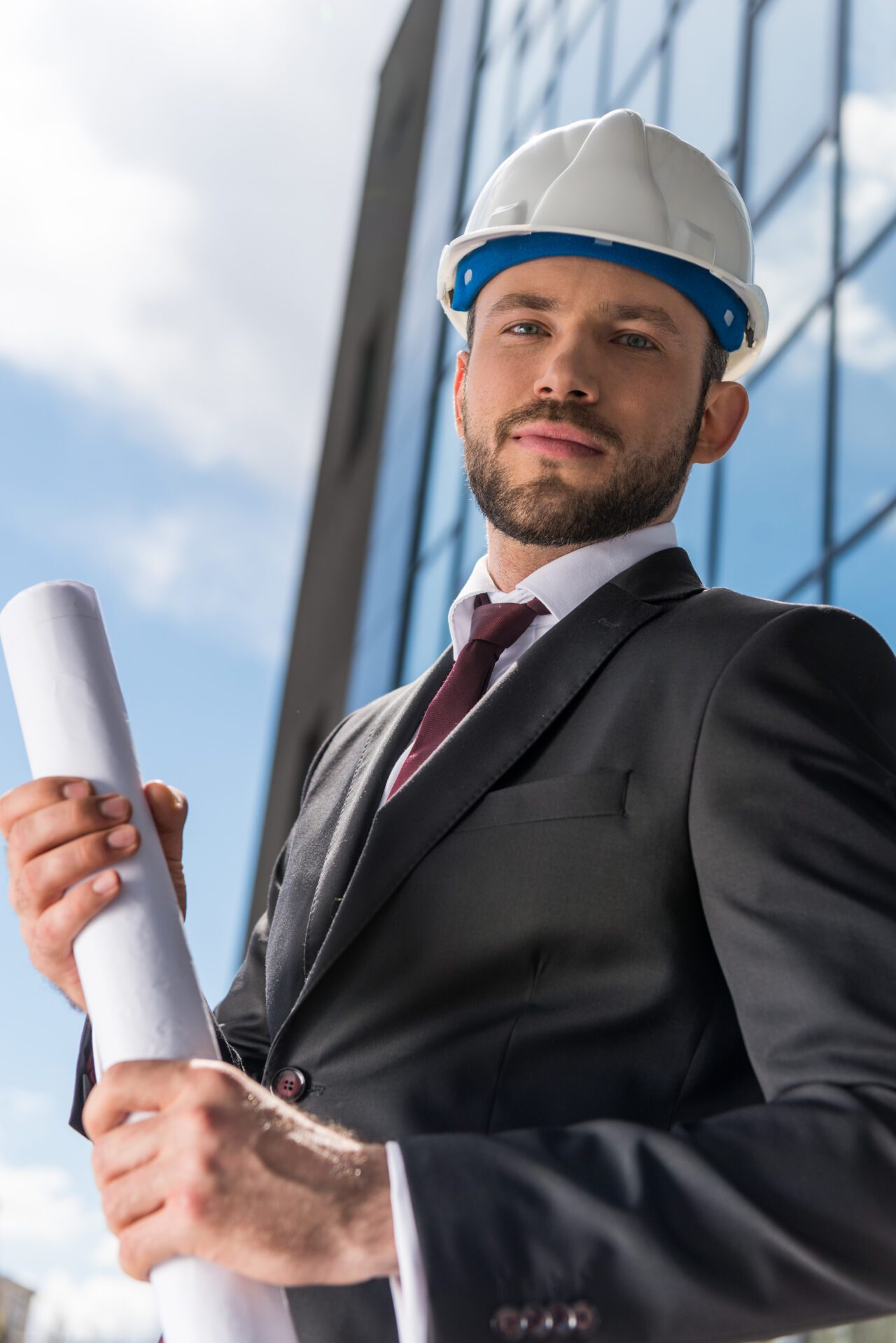I nostri servizi nelle soluzioni impiantistiche 2 professional architect in hard hat holding blueprint and looking at camera e1695837103902